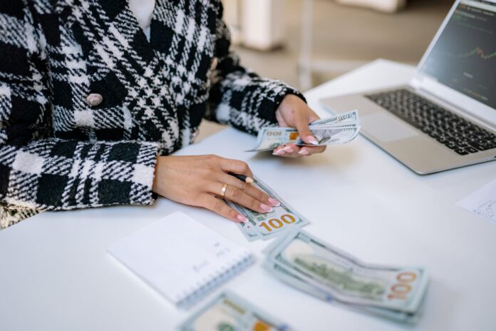 person sitting on the table counting money